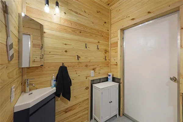 a bathroom with a toilet a sink and a mirror