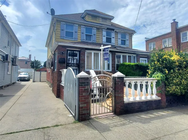 a front view of a building with a garden