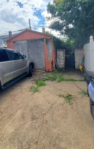 a backyard of a house with fire pit and barbeque oven