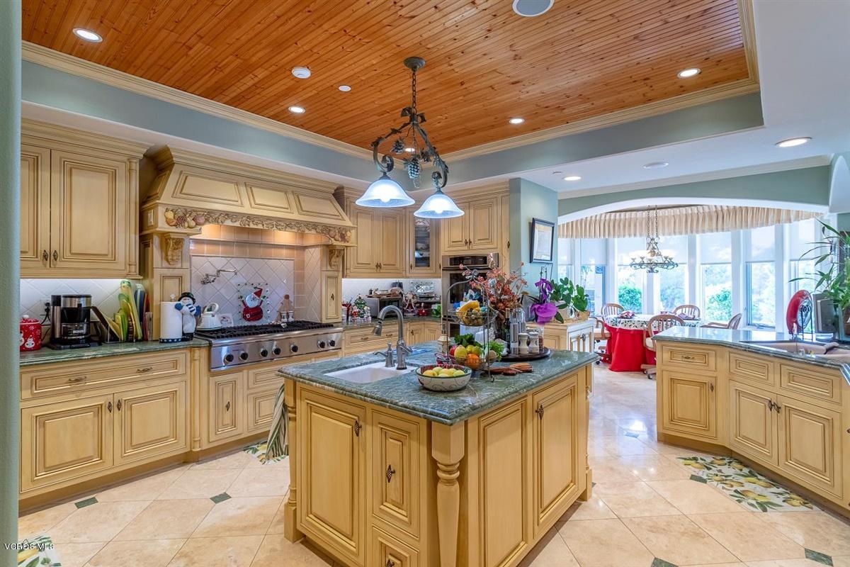6933 Solano Verde Drive Somis, CA 93066 - Photo 17 of 58 a kitchen that has a lot of white cabinets and stainless steel appliances
