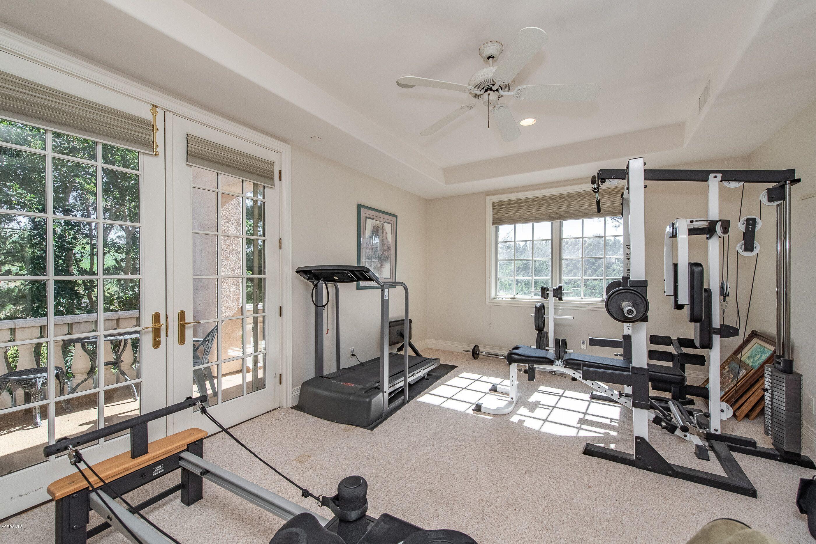 6933 Solano Verde Drive Somis, CA 93066 - Photo 35 of 58 a room with gym equipment and large mirror