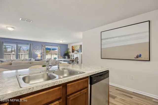 a kitchen with stainless steel appliances granite countertop a refrigerator and a cabinets
