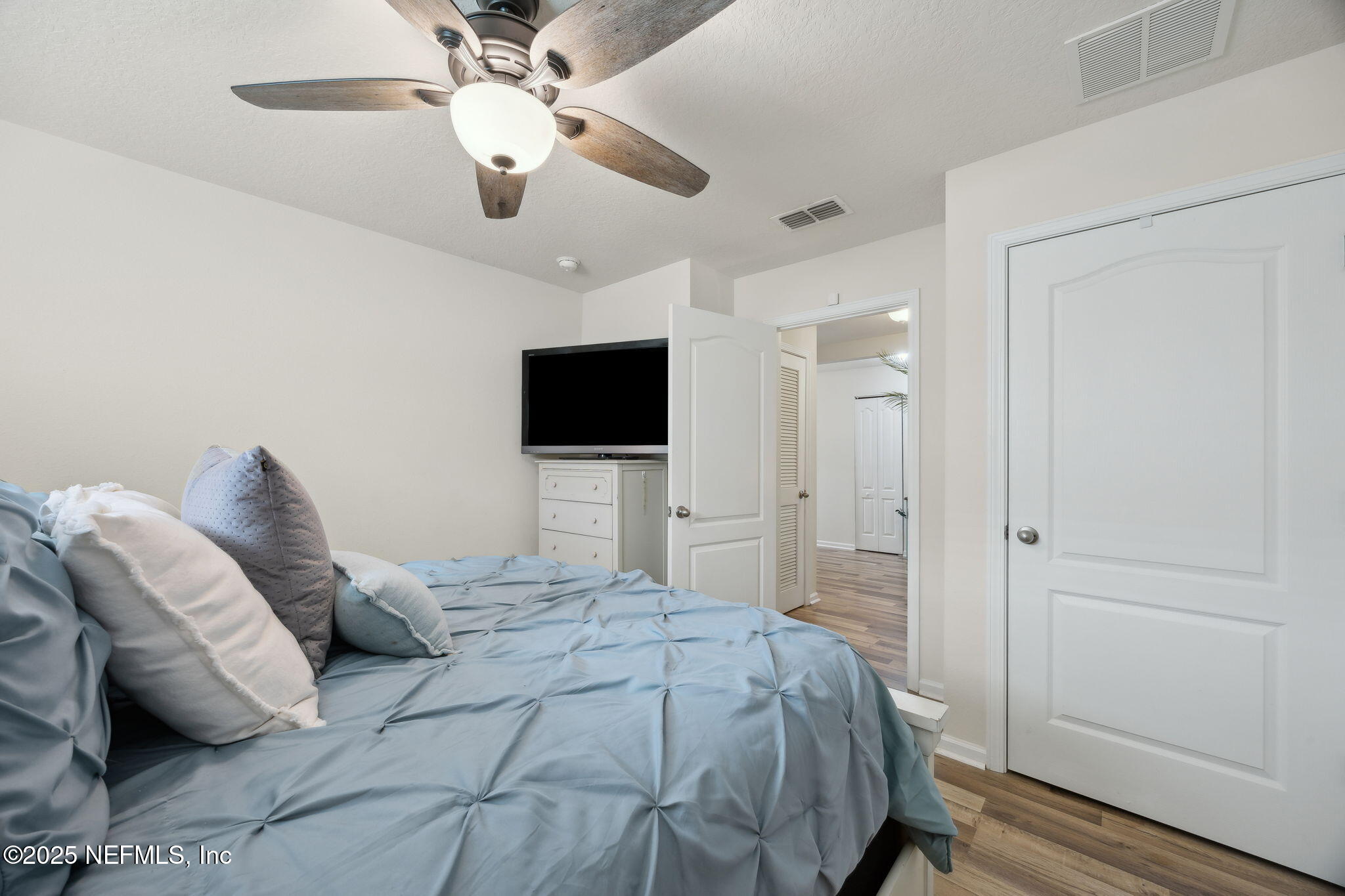 3356 Canyon Falls Drive Green Cove Springs, FL 32043 - Photo 23 of 66 a bedroom with a bed and a flat screen tv