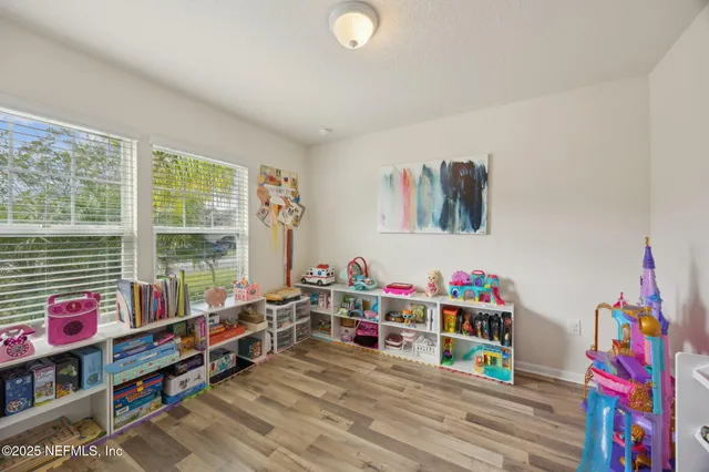 a view of a patio with table and chairs under an umbrella