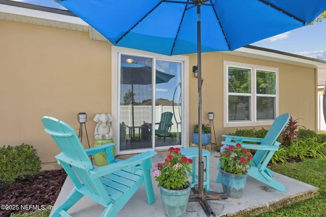 a view of a balcony with chairs potted plants