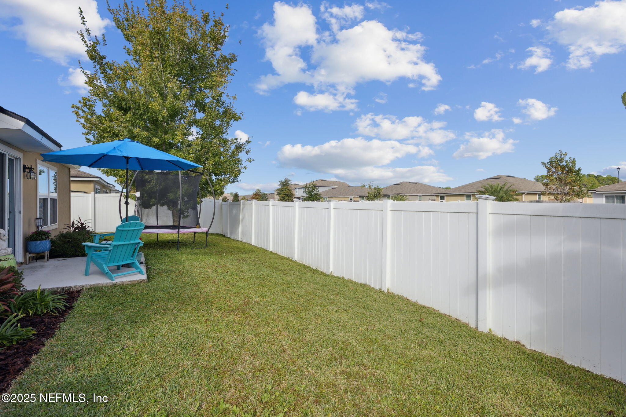 3356 Canyon Falls Drive Green Cove Springs, FL 32043 - Photo 32 of 66 a view of a patio with table and chairs under an umbrella