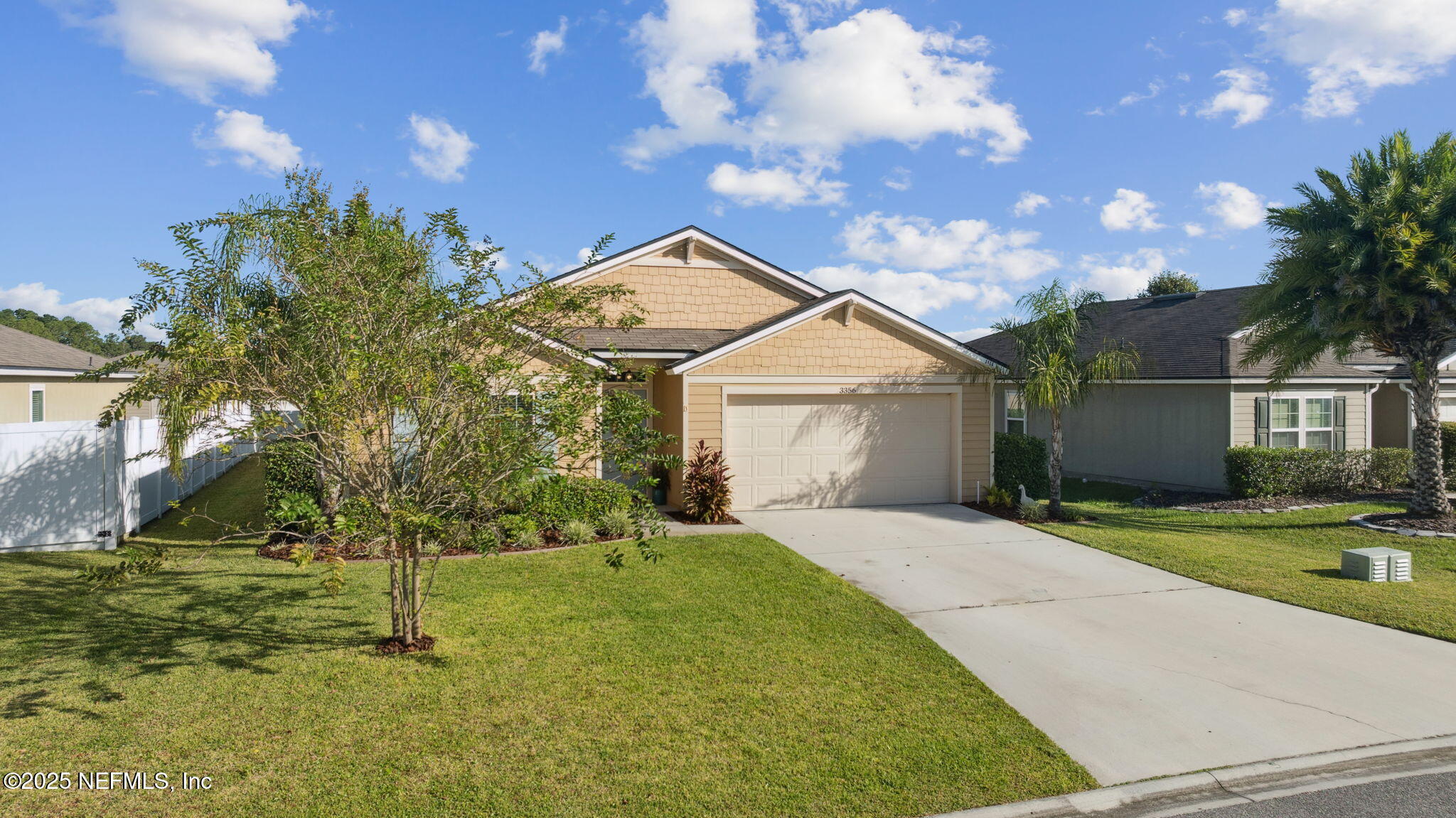 3356 Canyon Falls Drive Green Cove Springs, FL 32043 - Photo 35 of 66 a front view of a house with a yard and trees