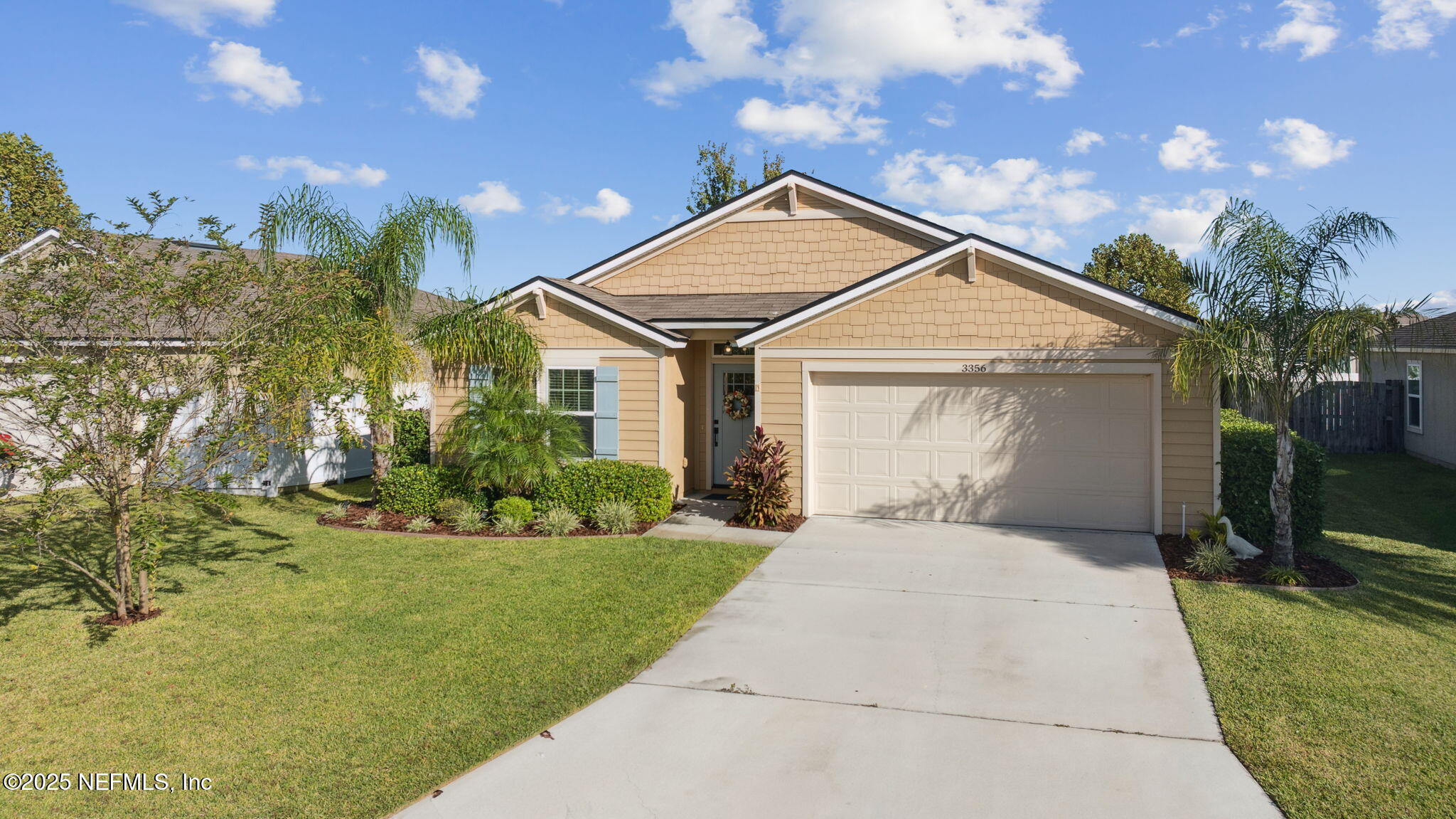 3356 Canyon Falls Drive Green Cove Springs, FL 32043 - Photo 36 of 66 a front view of a house with a garden and yard