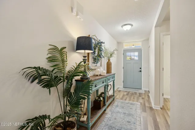 a view of entryway and hall with wooden floor