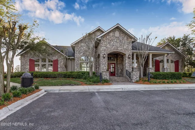 a view of a sign in front of a house with a big yard