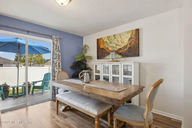 a dining room with furniture a rug and wooden floor