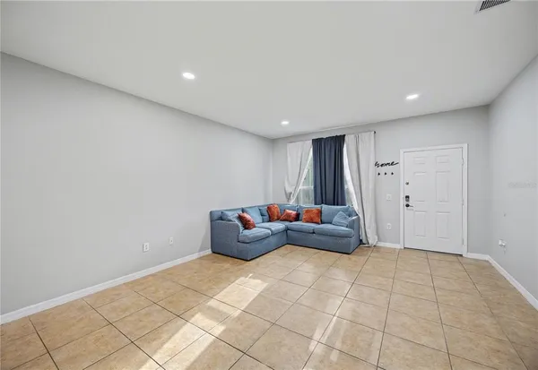 a living room with furniture and a rug