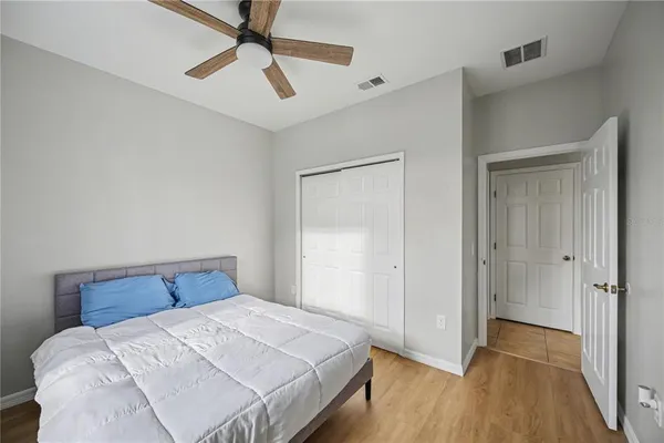 a bedroom with a bed and a ceiling fan