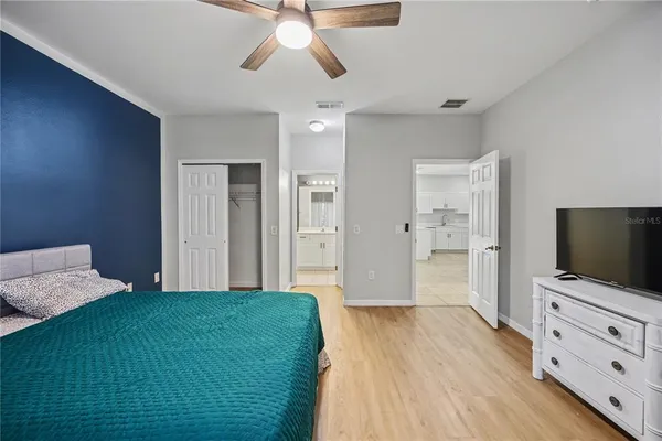 a bedroom with a bed and a flat screen tv