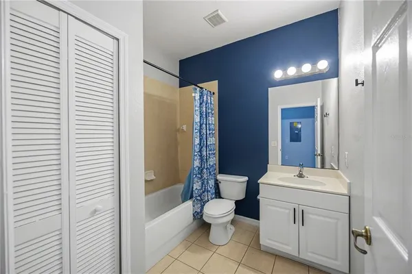 a bathroom with a toilet sink and shower