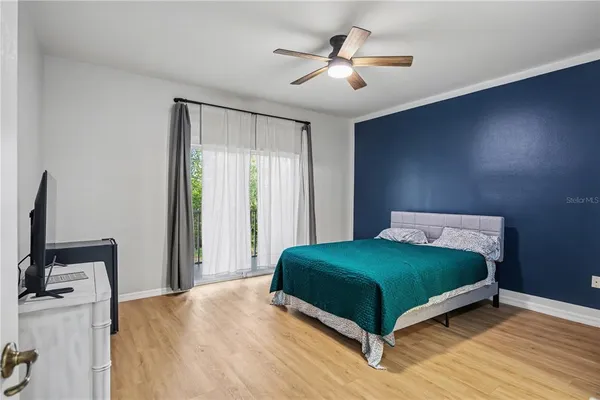 a bedroom with a bed and a flat screen tv