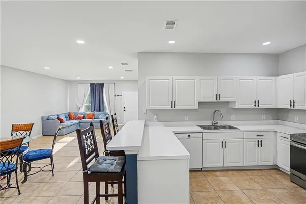 a view of a kitchen with dining table and chairs
