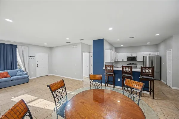 a living room with furniture and kitchen view