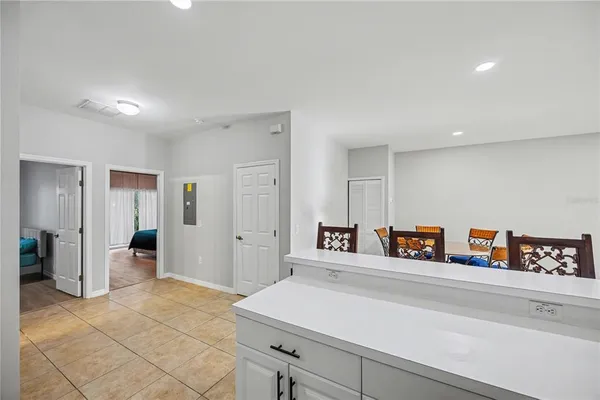 a room with a refrigerator and cabinets