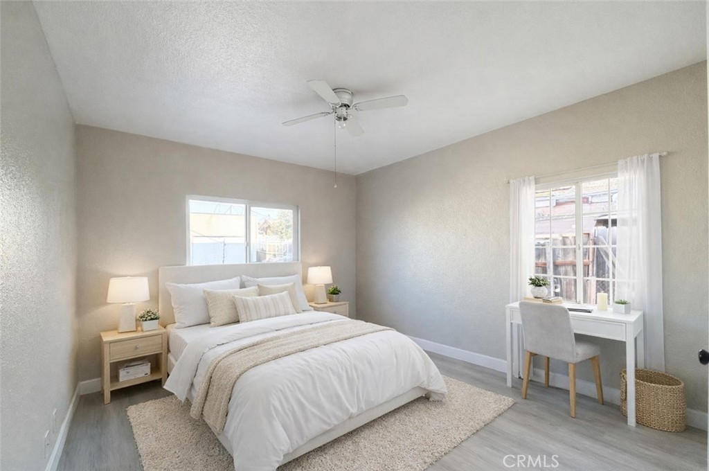 707 Harding Avenue Los Angeles, CA 90022 - Photo 2 of 12 a bedroom with a bed and a table chair