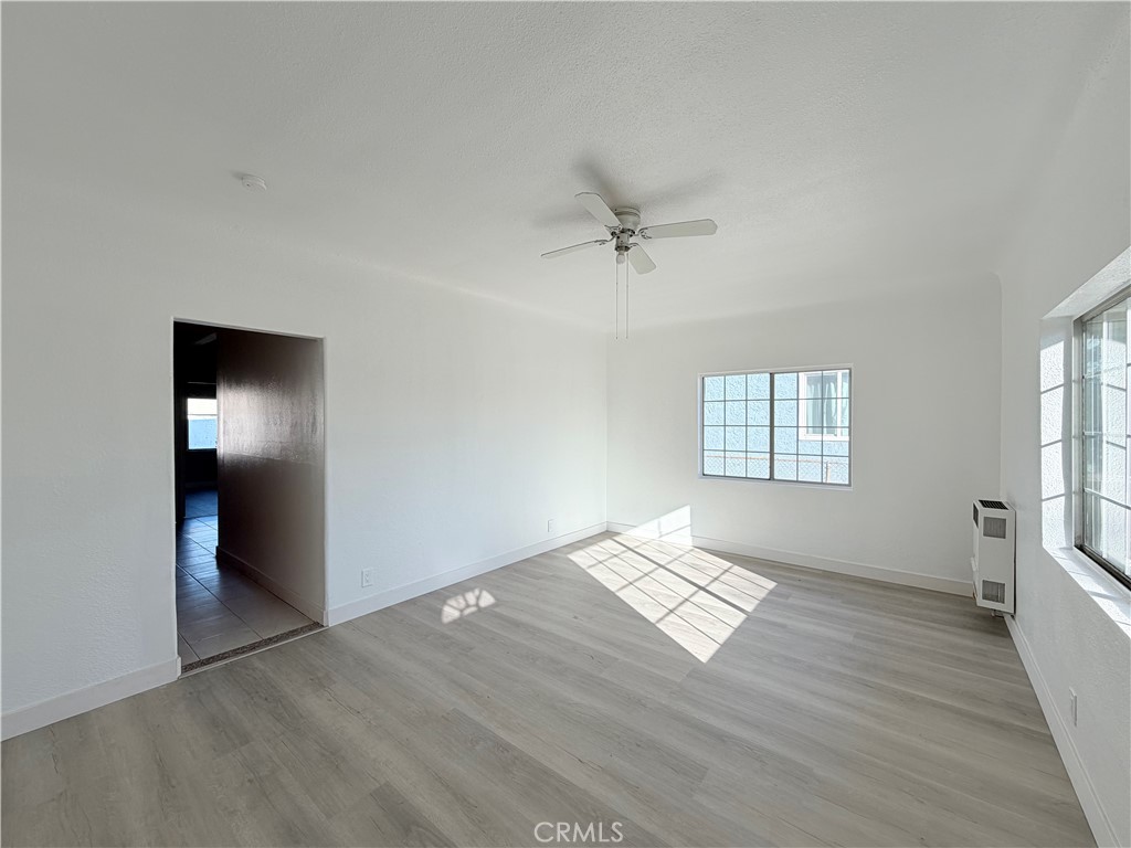 707 Harding Avenue Los Angeles, CA 90022 - Photo 4 of 12 wooden floor in an empty room with a window