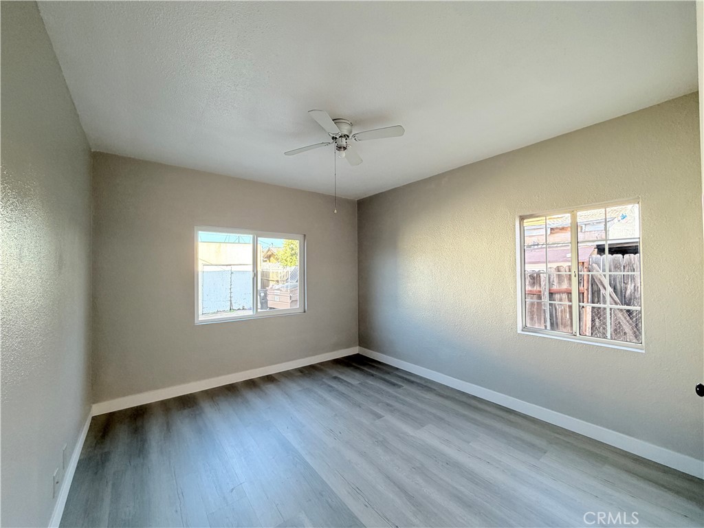 707 Harding Avenue Los Angeles, CA 90022 - Photo 8 of 12 a view of an empty room with wooden floor and a window
