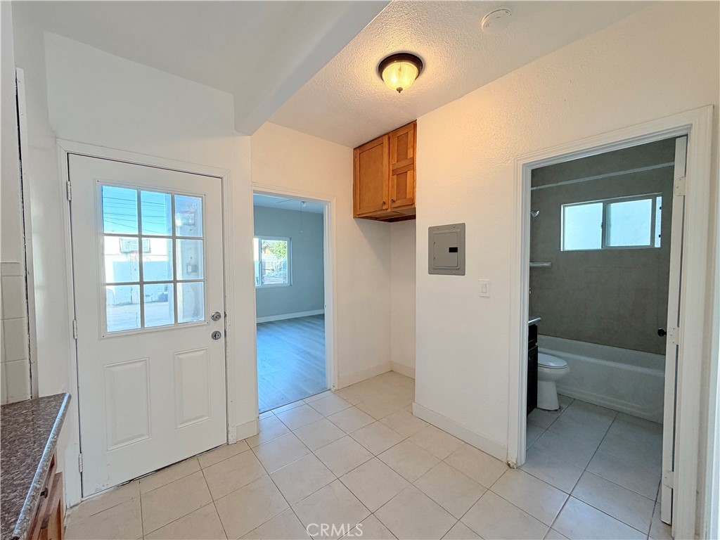 707 Harding Avenue Los Angeles, CA 90022 - Photo 9 of 12 wooden floor in an empty room and a window
