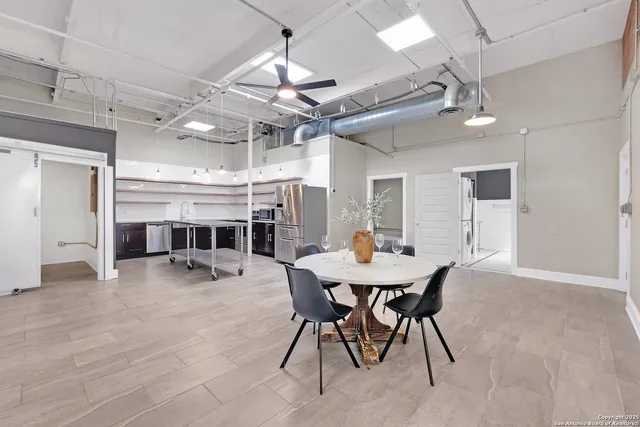a view of a dining room with furniture and a chandelier