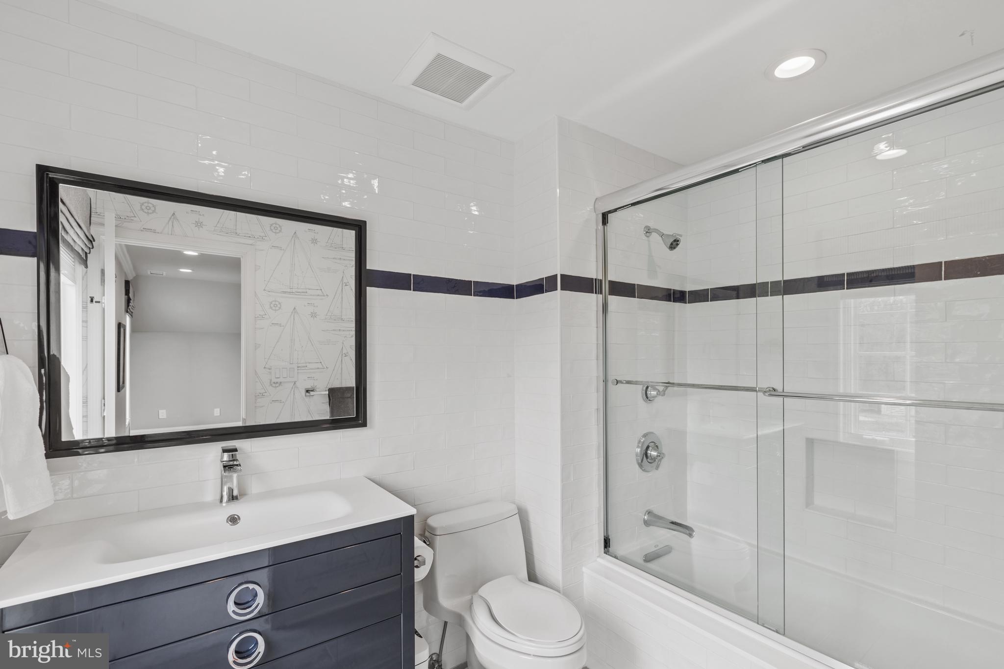 3054 Rundelac Road Annapolis, MD 21403 - Photo 37 of 49 a bathroom with a toilet a sink and a mirror