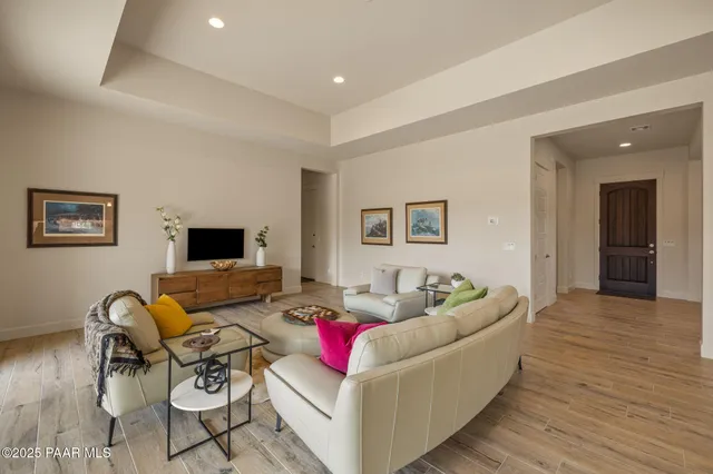 a living room with furniture and a wooden floor