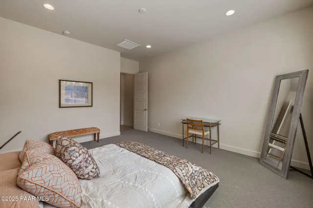 a bedroom with a bed and a couch