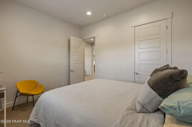 a bedroom with a bed and a chair