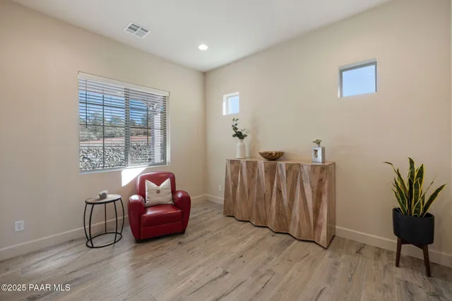 a living room with furniture window and wooden floor