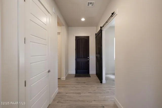 a view of hallway with wooden floor