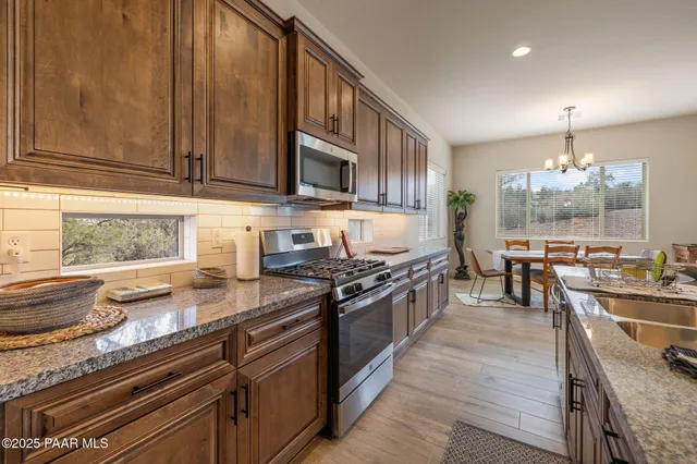 a kitchen with lots of counter top space and stainless steel appliances