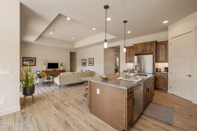 a kitchen with stainless steel appliances granite countertop a stove and a refrigerator