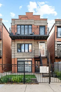 a front view of a residential apartment building with a yard