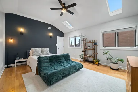 a spacious bedroom with a bed window and couch