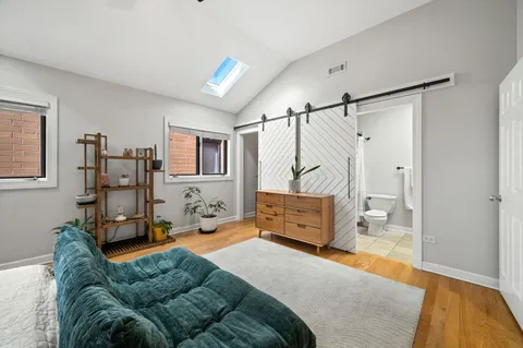 a bedroom with furniture and a wooden floor