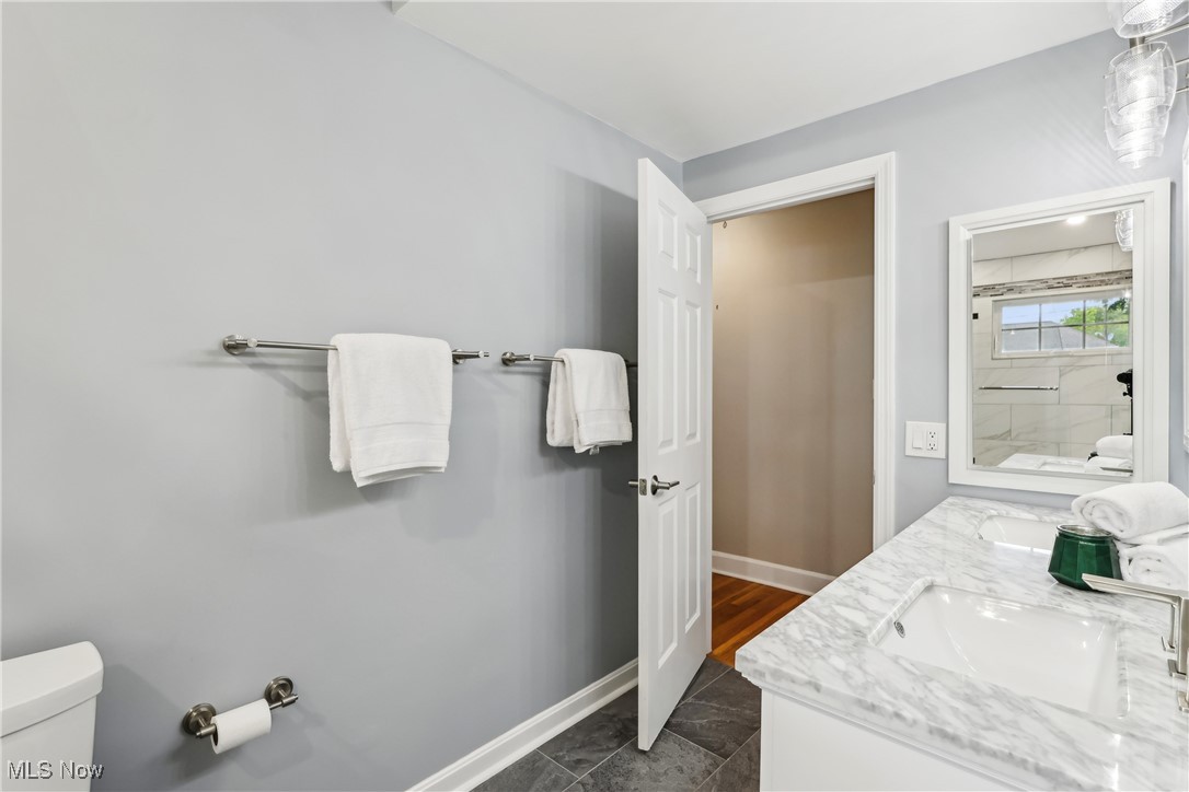3295 Braemar Road Cleveland, OH 44120 - Photo 23 of 43 Bathroom featuring toilet, double vanity, and baseboards