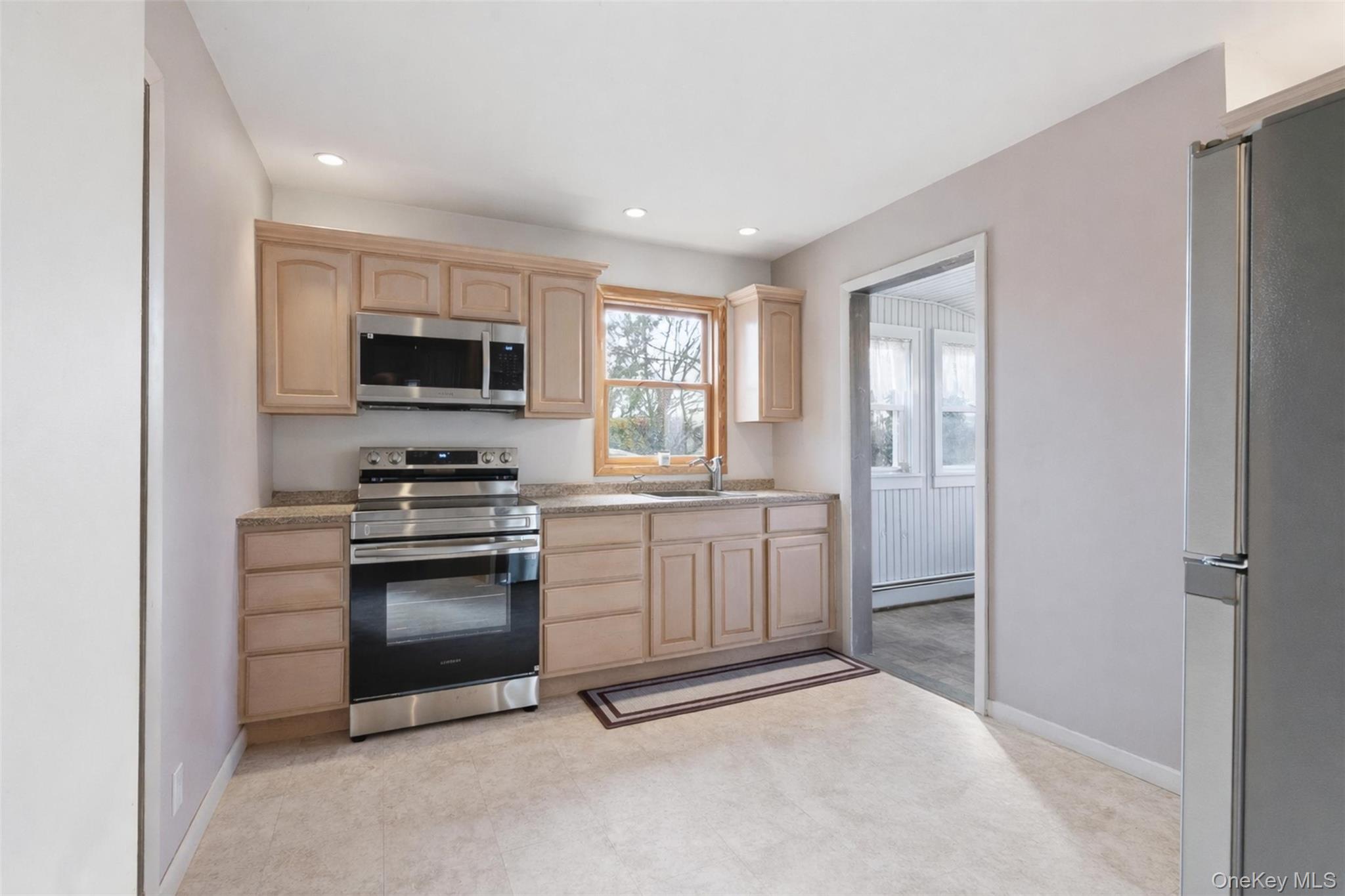 51 Johnson Street Lake Peekskill, NY 10537 - Photo 11 of 29 a kitchen with white cabinets and appliances