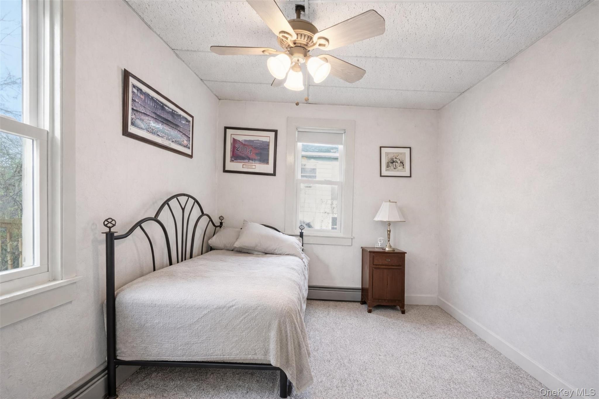 51 Johnson Street Lake Peekskill, NY 10537 - Photo 20 of 29 a bedroom with a bed and a chandelier