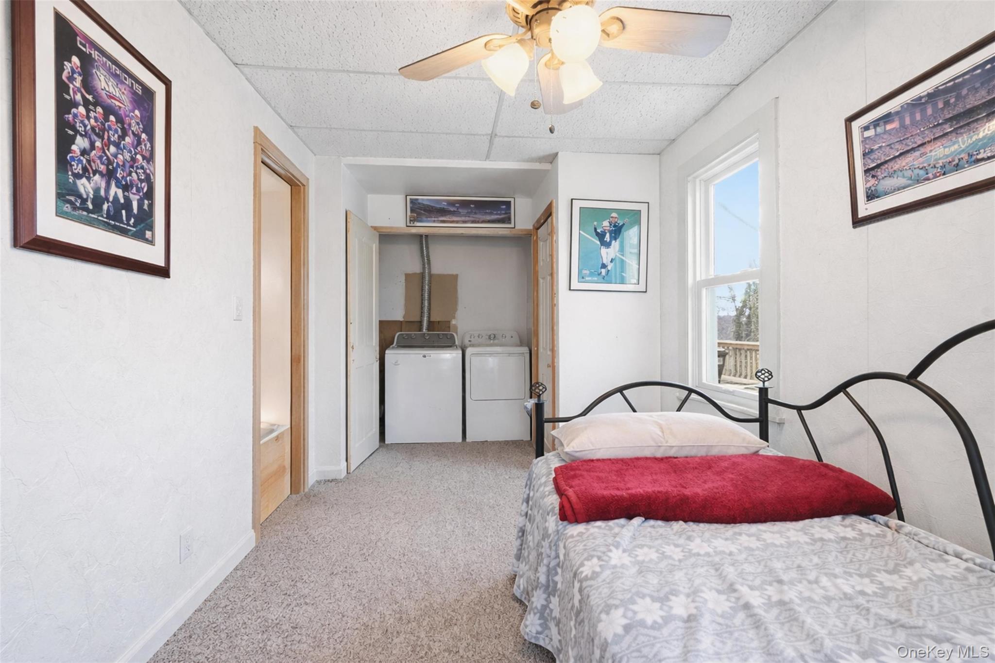 51 Johnson Street Lake Peekskill, NY 10537 - Photo 21 of 29 a bedroom with a bed and a chandelier