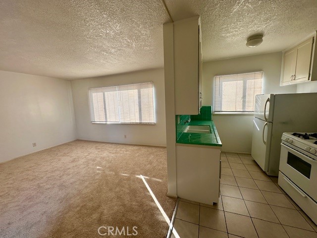 970 Elden Avenue, Unit 6 Los Angeles, CA 90006 - Photo 4 of 10 a kitchen with a sink and a stove top oven