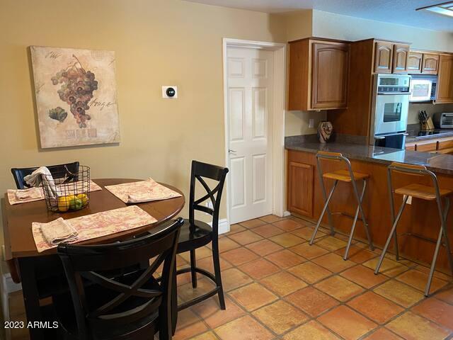 11222 North Miller Road Scottsdale, AZ 85260 - Photo 11 of 32 a view of a dining room with furniture