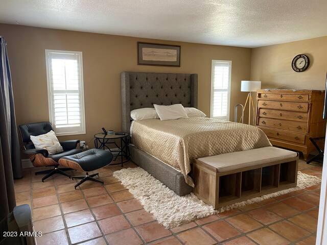 11222 North Miller Road Scottsdale, AZ 85260 - Photo 14 of 32 a bedroom with a bed and a couch