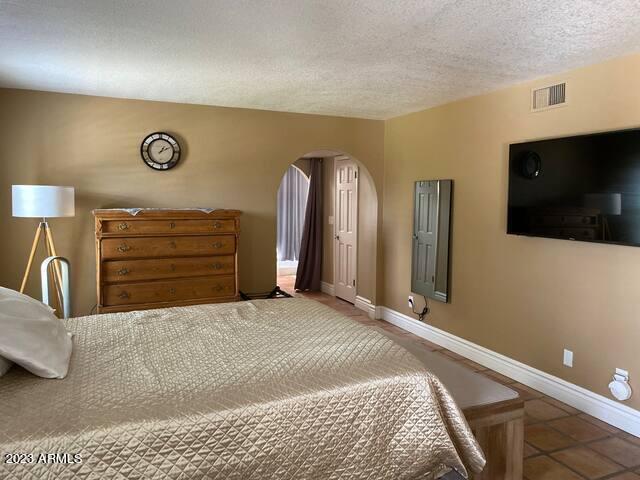 11222 North Miller Road Scottsdale, AZ 85260 - Photo 15 of 32 a bedroom with a bed and a television