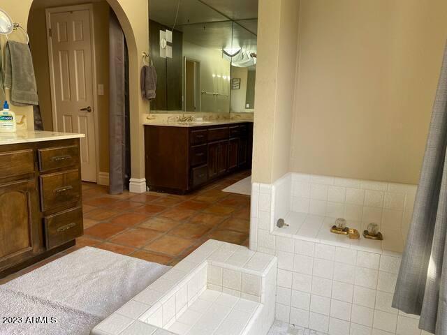 11222 North Miller Road Scottsdale, AZ 85260 - Photo 16 of 32 a bathroom with a tub sink and mirror