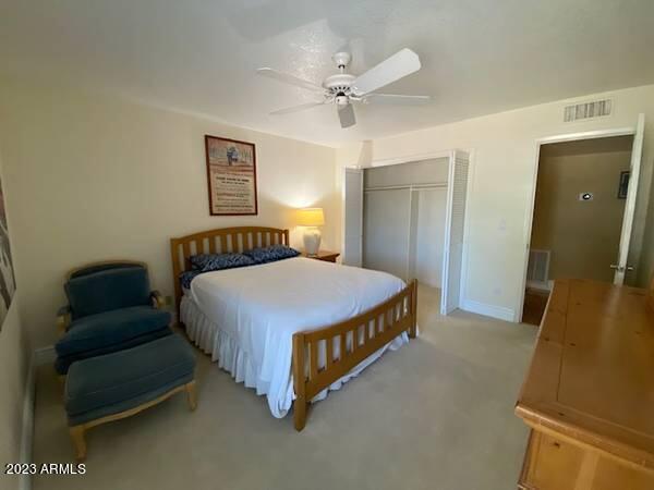 11222 North Miller Road Scottsdale, AZ 85260 - Photo 19 of 32 a spacious bedroom with a bed and a chandelier