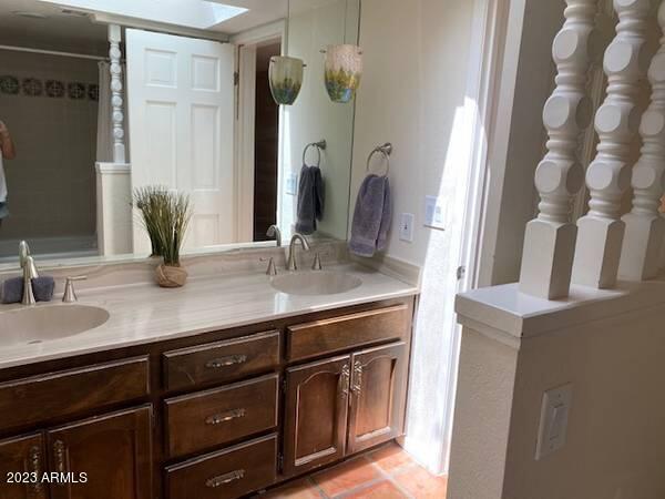 11222 North Miller Road Scottsdale, AZ 85260 - Photo 21 of 32 a bathroom with a double vanity sink and a mirror